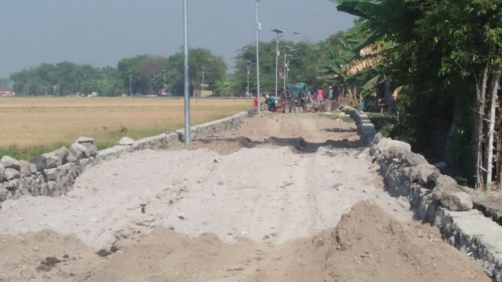 Anggota Satgas Bantu Pemasangan Paving Di Lokasi TMMD Desa Kupang